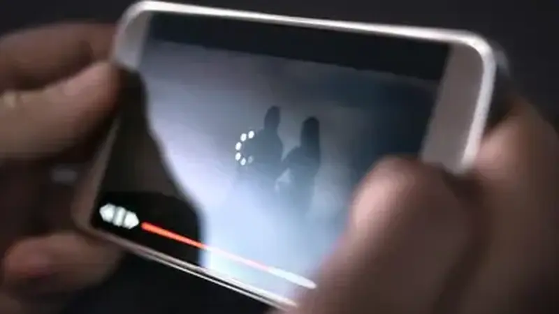 Phone showing a video loading spinner representing stream buffering issues
