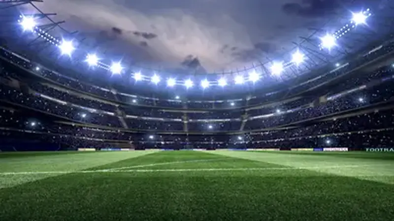 Football stadium at night with floodlights before a live match
