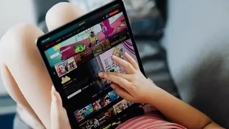 Tablet on a table displaying a live football match